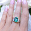 Transparent Green Emerald 3.16ct Cut with Two Emerald Cut Diamond 0.96ct surrounded 14K White Gold.